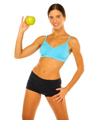 Young athletic woman holding a green apple in her hand - isolated on white background
