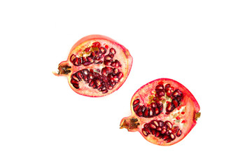 Fototapeta premium Pomegranate fruit isolated on a white background and a cut pomegranate. The concept of eating and eating meals. Eating fruit, providing vitamins.