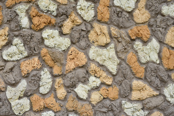 Multicolor stone wall of the large colored cement bonded patterns as a decorative background, texture