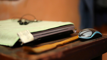 laptop computer with mouse and ear phone on work table front view