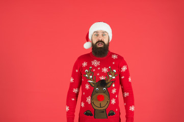 Last preparations. hipster man in red santa hat. happy winter holidays. new year party. christmas is here. man beard red background. surprised man with reindeer on sweater. traditional xmas look