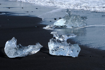 Ice Floes and chunks wash up on pristine black sand beaches on the southern Iceland Coast from...