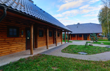 Traditional wooden house in the pine forest. Autumn in Europe.