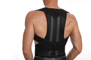 Attractive muscular man with posture corrector. Scoliosis, Kyphosis treatment