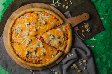 Pizza four cheese on a wooden platter. Quattro Formaggio