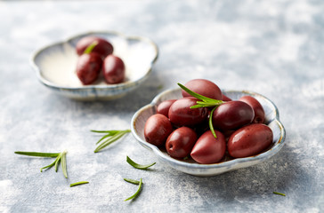 Kalamata olives on bright wooden background. Close up. 
