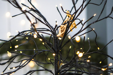 Beautiful yellow garlands in an interesting composition on the background of a Christmas tree. New Year theme for design