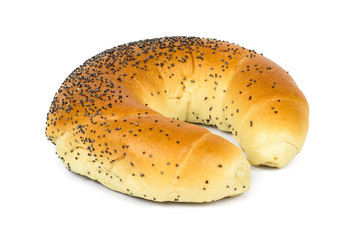 Crescent roll with poppy seeds on white background
