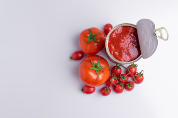 in of chopped canned tomatoes with whole fresh tomatoes, isolated on white background, soft light