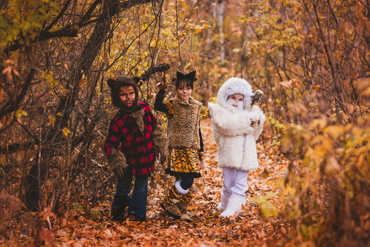 Three Children in the forest dressed up for Halloween, United States