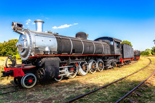 Old retro steel locomotive train standing on the rails in Livingstone, Zambia