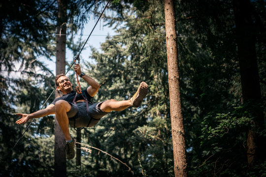 Smiling man on a zip line