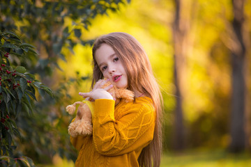  Girl, autumn, ginger color jumper, toy dog, sad