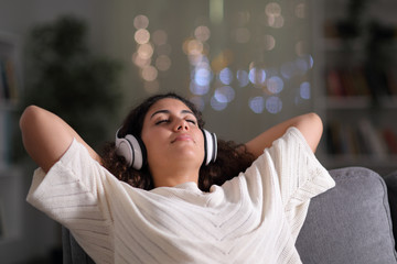 Relaxed tenant resting listening to music at home
