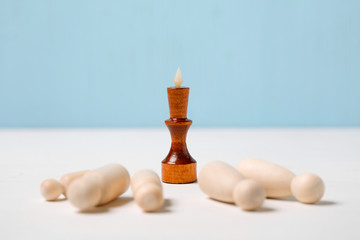 The concept of competition, the victory of the fittest. The figure of the wooden king in front of...