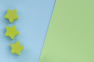Kids toys on pastel blue green paper background. Top view on children's educational games. Wooden stars. Flat lay, copy space