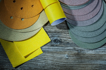 set of abrasive tools sanding discs and sandpaper on vintage wood