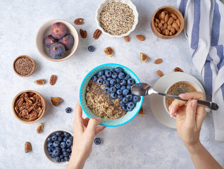 Ingredients for a healthy breakfast, quinoa with blueberry, fig, honey and nuts. Concept vegan and healthy eating. Top view