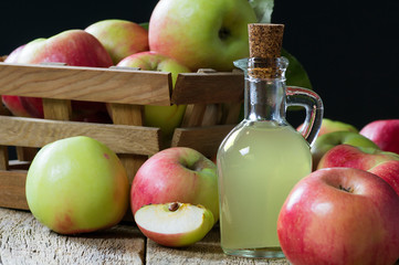 Glass bottle of handmade organic apple cider vinegar made from fermented fresh ripe apples. Healthy organic food