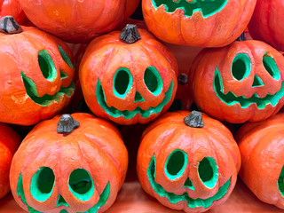 Halloween artificial orange pumpkins. Pumpkin heads background for festival. Close up. Halloween pumpkin head jack lanterns 