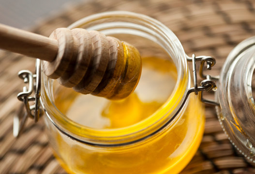 honey with wooden spoon macro