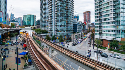 Downtown Vancouver. Skytrain in Downtown Vancouver, with people just about attending to a game on...