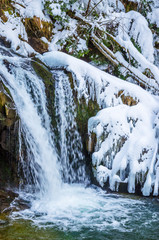 Beautiful mountain river waterfall in winter