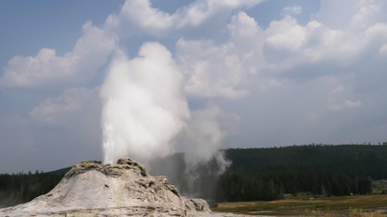 close up of castle geyser erupting in yellowstone