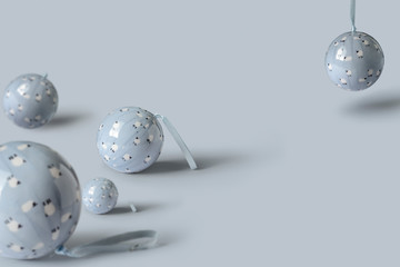 pastel Christmas decoration balls on soft blue background. Minimal New year concept with creative copy space.