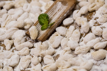 Cook handmade gnocchi on the table, Italian tradition