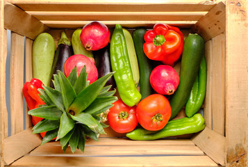 Old wooden box with freshly harvested vegetables and fresh fruits