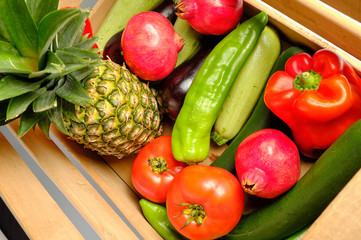 Old wooden box with freshly harvested vegetables and fresh fruits