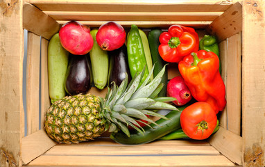 Old wooden box with freshly harvested vegetables and fresh fruits