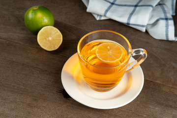 Lemon tea in a clear glass on white plate,  Lemon tea recipe