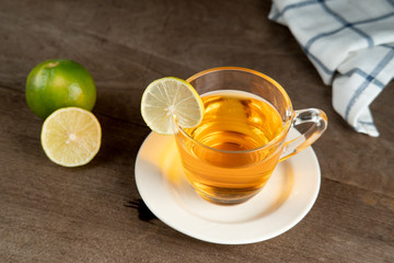 Lemon tea in a clear glass on white plate,  Lemon tea recipe