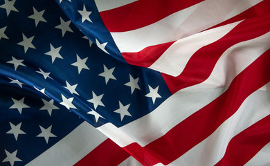 Close-up of ruffled American flag, light painted background - USA