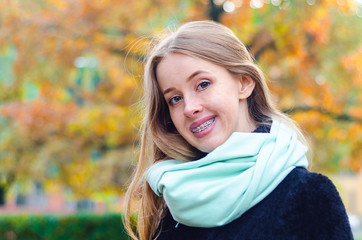 redhead girl with freckles and braces. treatment at the dentist orthodontist. metal bracket system....