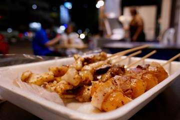 Grilled meat and vegetable, street food at night market in Thailand 