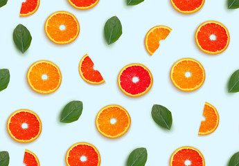 Pattern half cut with orange fruits and grapefruit with leaf petals on white background