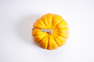 orange pumpkin on white marble background