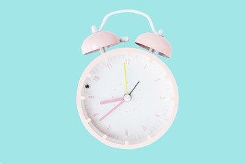 Vintage alarm clock pink color Isolated on trendy blue background. Rest hours time of life good. Flat lay, top view, copy space, mockup, overhead