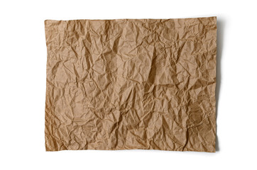 A sheet of brown, crumpled paper, on a white background.