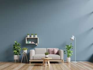 Living room interior with sofa and green plants,lamp,table on dark blue wall background.