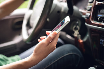 woman using smartphone in a car