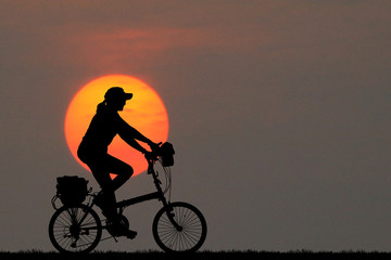 Silhouette  Cycling  on blurry sunrise  sky   background.