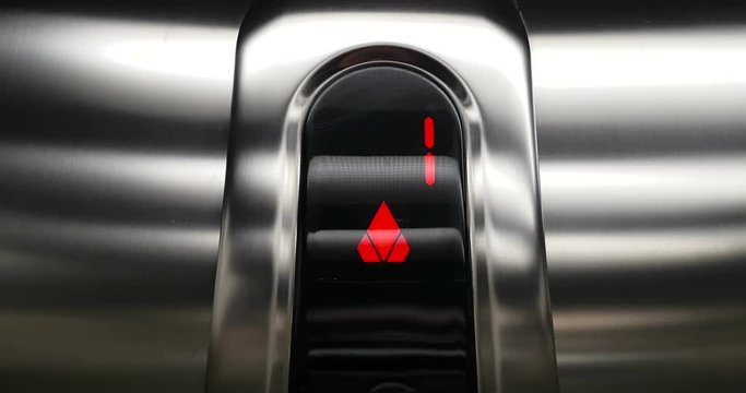 detail of red led number of elevator that go up from first to second floor, business and technology