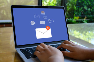 Person using a laptop computer with email communication connection message online and chat on social media with global letters concept. Laptop mockup with clipping path on screen.
