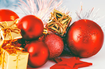 Christmas red balls and gifts in golden boxes.