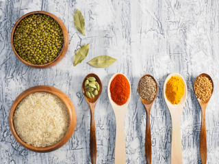 Tasty and healthy nutrition - rice with spices. Indian cuisine ingredients  on a white concrete background