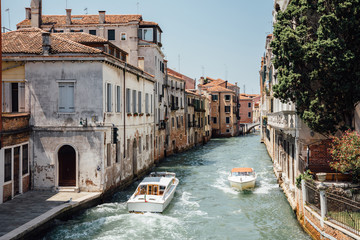 Fototapeta na wymiar Panoramic view of Venice narrow canal with historical buildings and boats